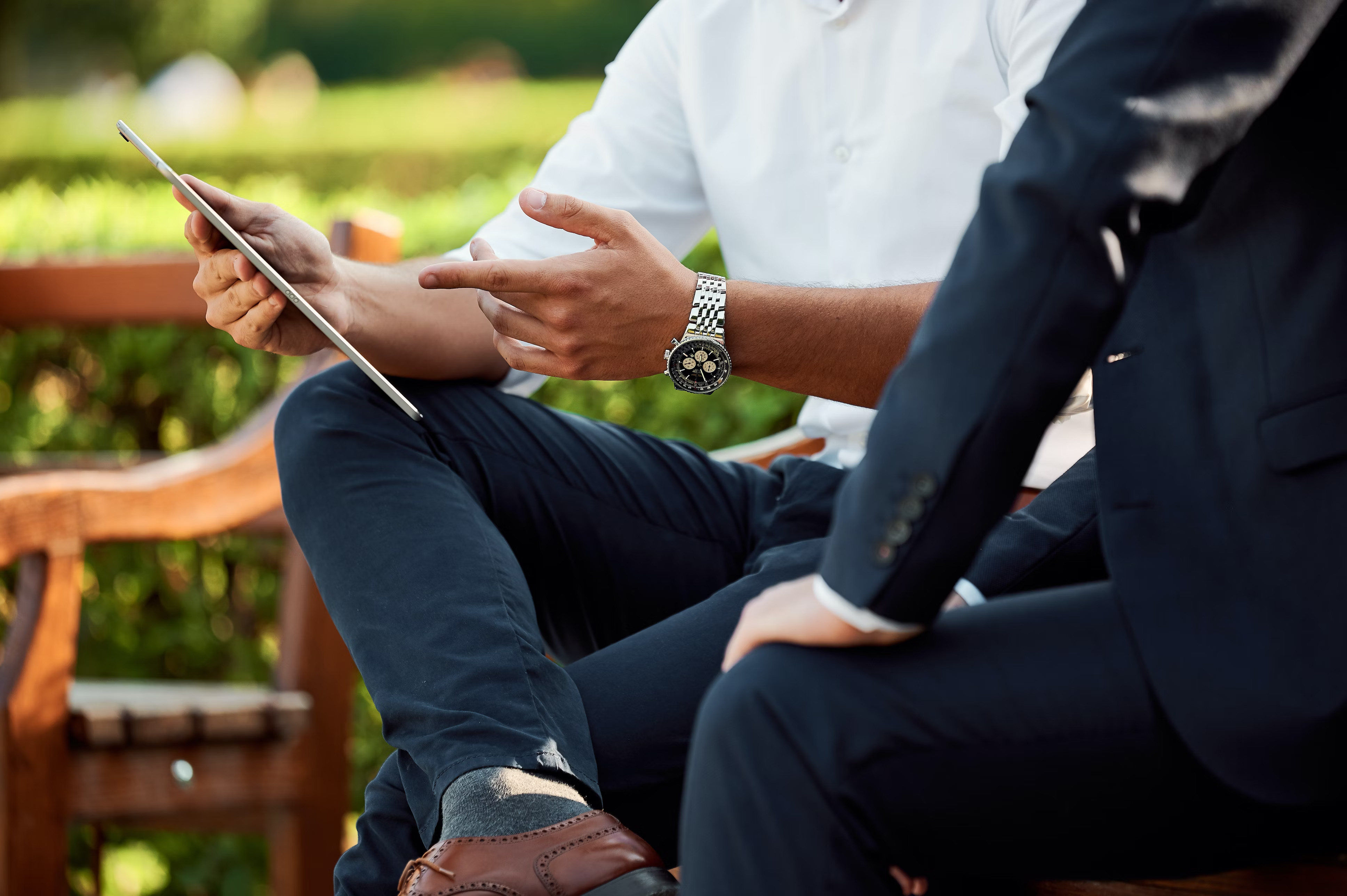 Bevan Buckland Accountants two men in suits pointing at iPad