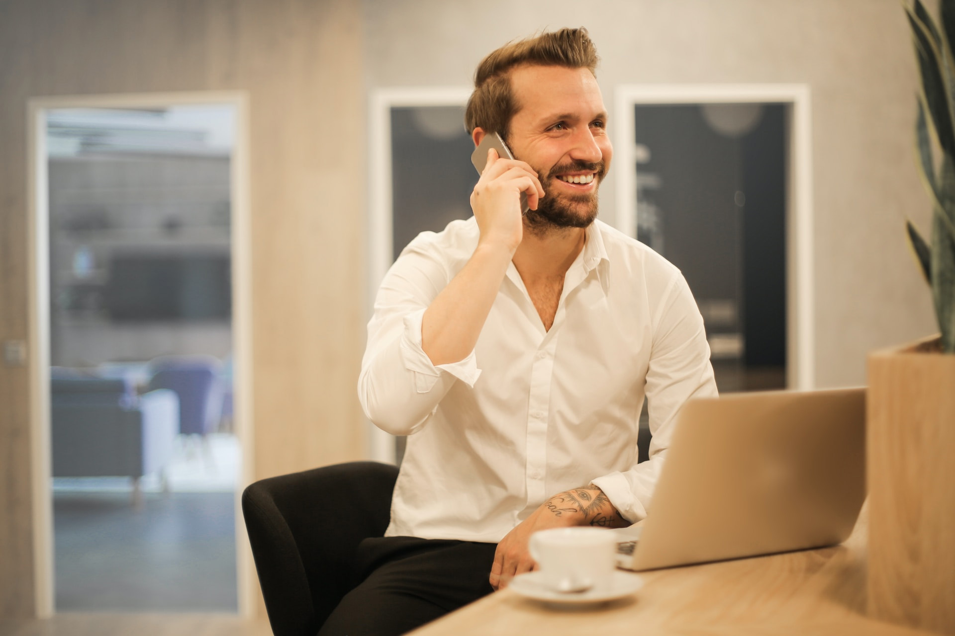 Bevan Buckland Accountants smiling man on phone in office