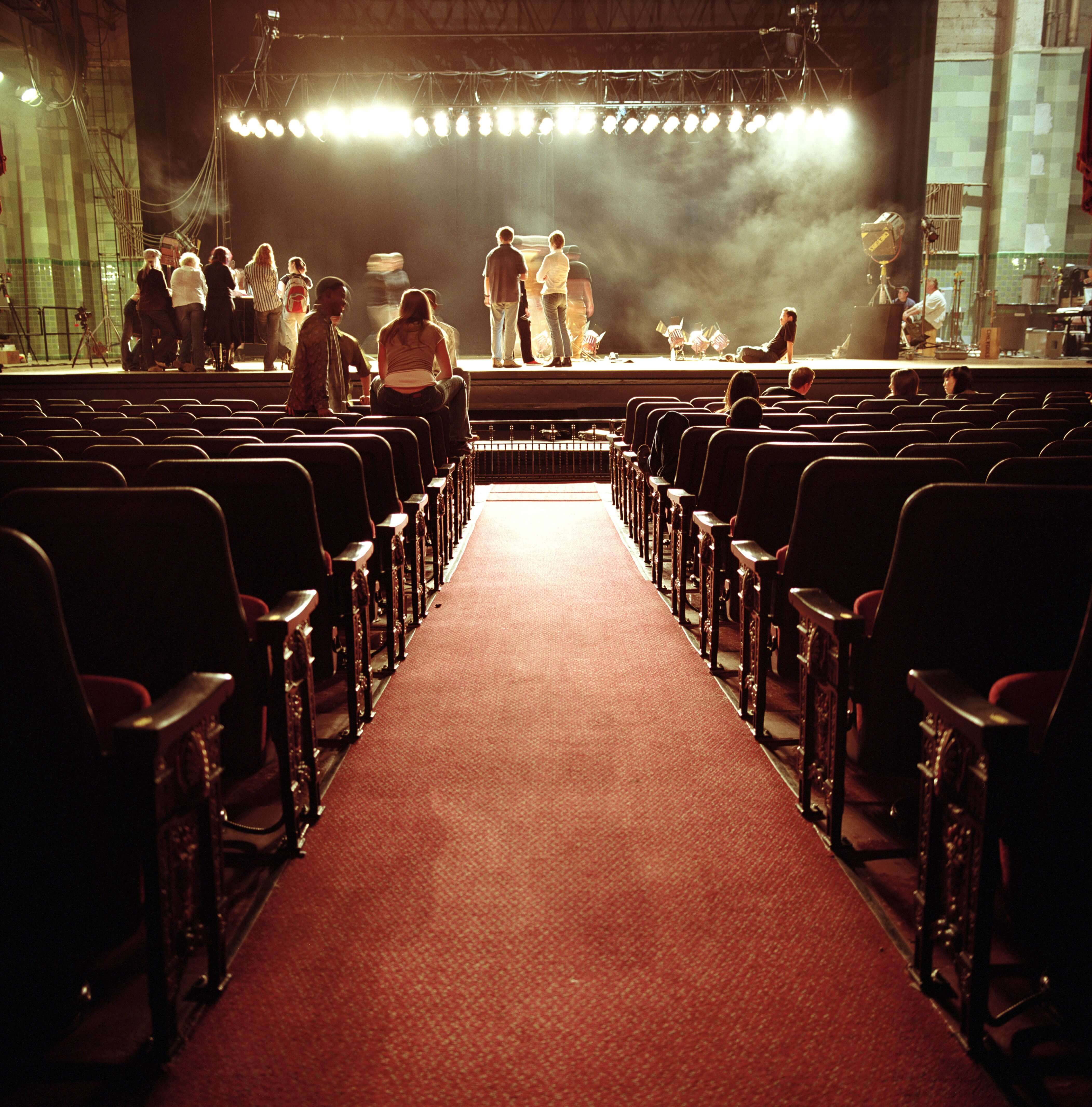 Bevan Buckland Accountants for Creative Industries. Shot form back of small theatre of rehearsals on stage